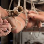 Caucasian girl is penetrated by a dildo stick during suspension bondage