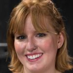Redheaded MILF Mz Berlin dominating two submissive hotties in metal bondage