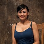 Dark-haired woman has her nipples tortured while restrained to a wall